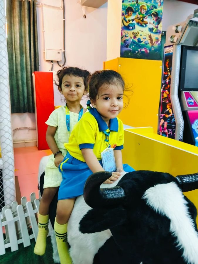 Two children on a soft-toy ride during an outing