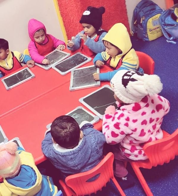 Children writing on slates in the classroom